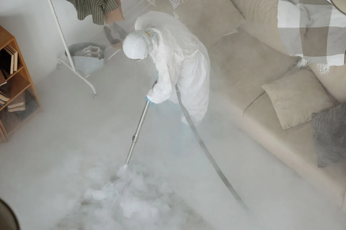 Biohazard cleanup technician in protective equipment, Oberlin, KS